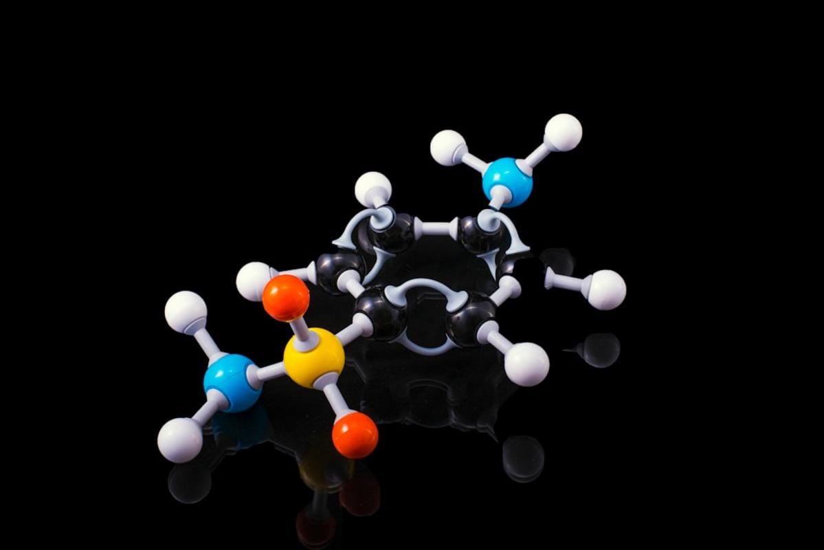 A researcher in a Dutch lab synthesizing polymers with advanced organic chemistry techniques